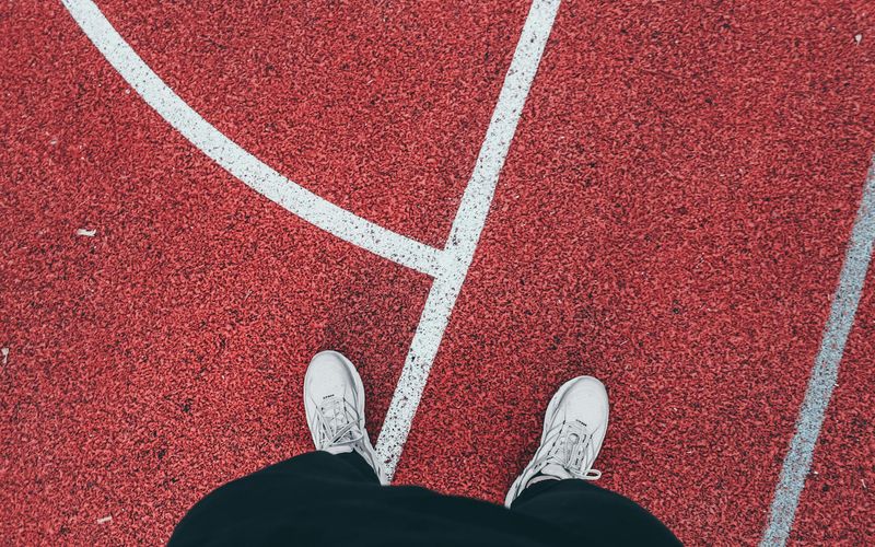Detailed view of sports sneakers on asphalt